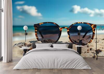 Chic Sunglasses on Sandy Beach with Ocean Waves and Bright Blue Sky, Embracing the Essence of Summer Vacation Wall mural