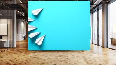 Colorful paper planes soaring against a vibrant blue backdrop Wall mural