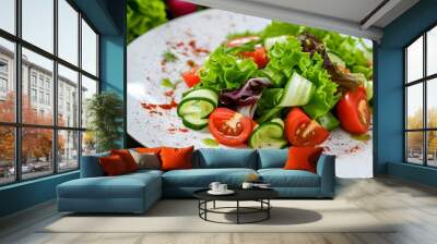 Colorful salad creation featuring fresh lettuce, tomatoes, cucumbers, and bell peppers elegantly presented on a white plate by a skilled waiter Wall mural