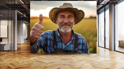 Confident farmer celebrating success with thumbs up in a flourishing field Wall mural