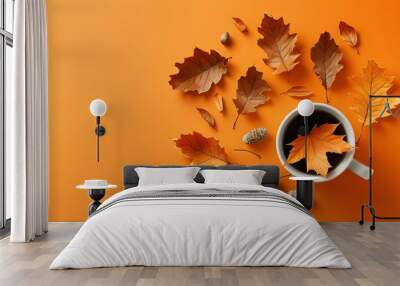 Creative autumn composition featuring dried leaves in a cup on a vibrant orange background, embodying the essence of fall with a flat lay perspective. Wall mural