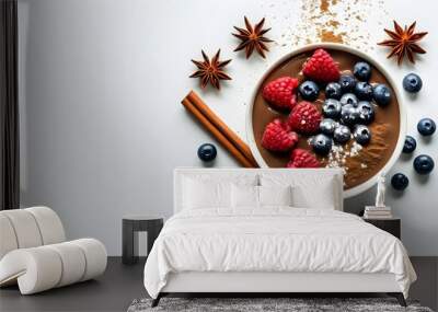 Decadent chocolate yogurt bowl topped with fresh berries, cinnamon, and star anise on a crisp white background Wall mural