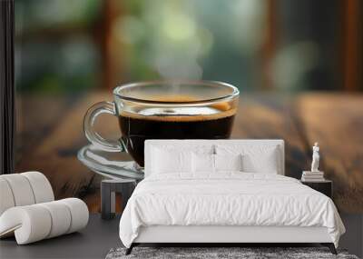 Elegant glass mug of black coffee resting on rustic wooden table with a softly blurred background Wall mural