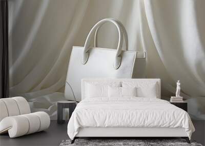 Elegant white leather handbag on soft fabric backdrop, embodying minimalist sophistication Wall mural