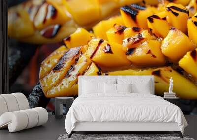 Grilled mango slices with char marks on barbecue grill for summer culinary delight Wall mural