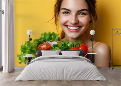 Joyful woman enjoying a vibrant vegetable salad, embodying a healthy lifestyle in a bright, casual setting Wall mural