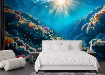 Lively underwater coral reef bathed in sunlight, showcasing a vibrant array of corals and diverse marine life swimming amidst crystal clear waters Wall mural