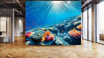 Lively underwater coral reef bathed in sunlight, showcasing a vibrant array of corals and diverse marine life swimming amidst crystal clear waters Wall mural