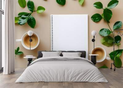 Minimalist flat lay of a blank white spiral notebook amidst coffee and green leaves on a pristine white backdrop Wall mural