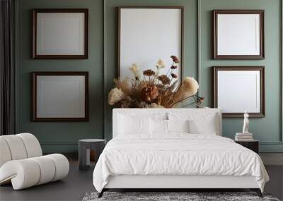 Minimalist room featuring empty frames on the wall and a vase of dried flowers as a focal point Wall mural