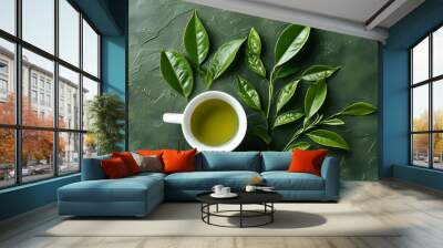 Refreshing green tea in a white cup surrounded by leaves on a textured background, perfect for a healthy lifestyle and relaxation themed design Wall mural