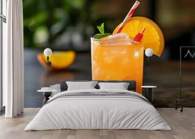 Refreshing summer orange cocktail with ice and an orange slice garnish, complemented by a straw Wall mural