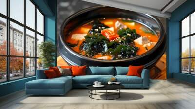 Savory seaweed soup with tender meat served in a stylish black bowl Wall mural