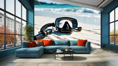 Serene beach scene featuring a solitary scuba mask and snorkel on fine white sand with clear blue ocean waves in the background Wall mural