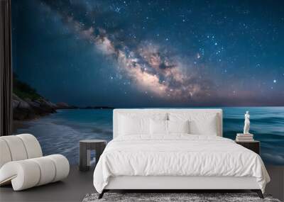 Serene beach under a starry night sky featuring the Milky Way and gentle ocean waves Wall mural