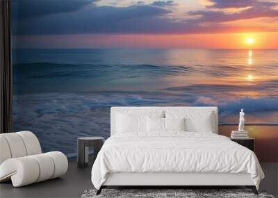 Serene sunset over gentle waves lapping against sandy shores, creating a peaceful summer beach seascape backdrop Wall mural