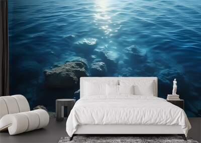 serene underwater realm illuminated by gentle ocean light, where dark blue waters create a captivating atmosphere of peace and calm Wall mural