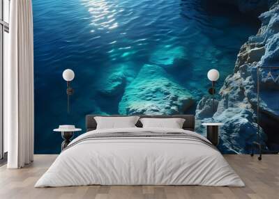 serene underwater realm illuminated by gentle ocean light, where dark blue waters create a captivating atmosphere of peace and calm Wall mural