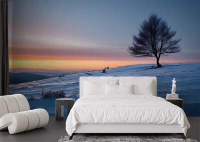 Serene winter landscape featuring a solitary tree on a snow-covered hill at dawn Wall mural