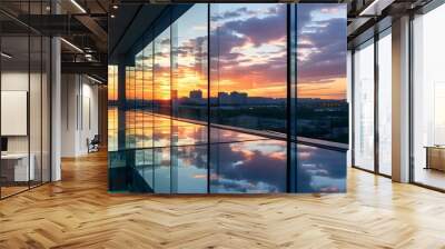 Sleek glass corridor reflecting vibrant sunset hues and urban scenery beyond the windows Wall mural