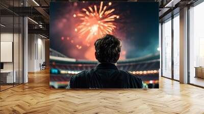 Soccer player admiring fireworks display above vibrant football stadium Wall mural