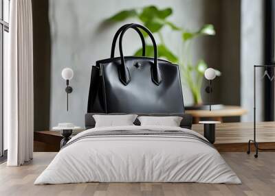 Stylish black leather handbag displayed on a wooden table in a contemporary setting, ideal for everyday elegance Wall mural