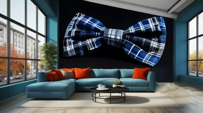 Stylish blue and grey checkered bow tie elegantly displayed against a sleek black backdrop Wall mural