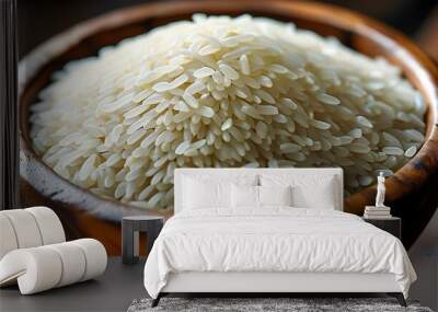 Textured wooden bowl brimming with uncooked white rice, showcasing simplicity and natural beauty Wall mural