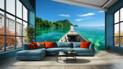 Tranquil wooden boat drifting on crystal-clear turquoise waters beside a lush green island beneath a vibrant blue sky Wall mural