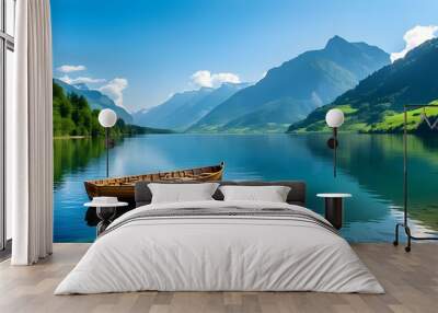 Tranquil wooden boat floating on a crystal clear lake amid lush green mountains under a bright blue sky Wall mural