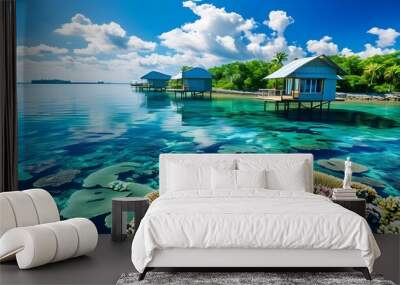 Tropical paradise with overwater bungalows, crystal-clear turquoise waters, vibrant coral reefs, and a serene blue sky Wall mural