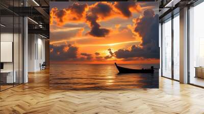 Tropical sunset silhouette of a boat on the sea with vibrant orange clouds painting the sky Wall mural