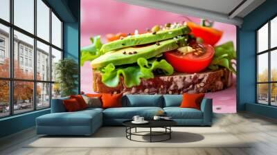 Vibrant close-up of a delicious vegan sandwich featuring tempeh, avocado, tomato, and lettuce on whole grain bread against a pink backdrop Wall mural