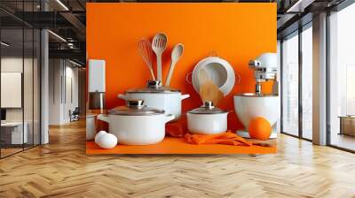 Vibrant display of white kitchen utensils against a bold orange backdrop Wall mural