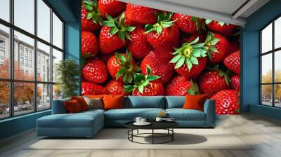 Vibrant red backdrop of freshly gathered organic strawberries showcases delightful sweetness and health in a visually enticing close-up display Wall mural