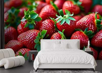 Vibrant strawberries piled high, displaying juicy red hues and lush green leaves, ideal for summer culinary creations Wall mural