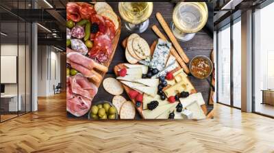 Food antipasto prosciutto ham, salami, olives and grissini bread sticks. cheese on a board parmesan, pecorino, gorgonzola. Charcuterie board. Two glasses of white wine or prosecco Wall mural