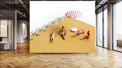 Miniature people : man and woman sunbathing relaxing on beach, ocean view,Beach vacation concept. Wall mural