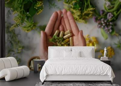 A close-up of hands gently holding a selection of herbal supplements, with fresh herbs and plants in the background, promoting the benefits of natural remedies and holistic health Wall mural