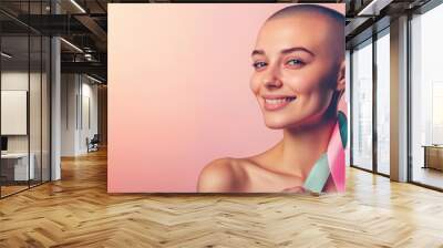 A woman with a shaved head, a symbol of her battle with breast cancer, smiling softly while holding a pink ribbon, set against a serene, pastel-colored background that symbolizes hope and healing Wall mural