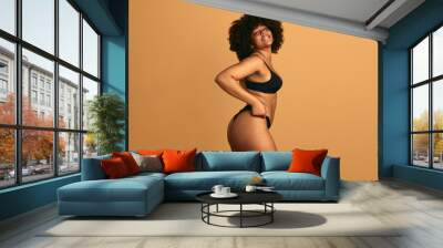 Alluring black woman in underwear looking at camera Wall mural