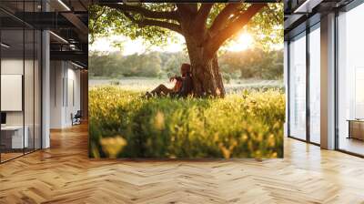 Bearded man relaxing under tree in nature Wall mural