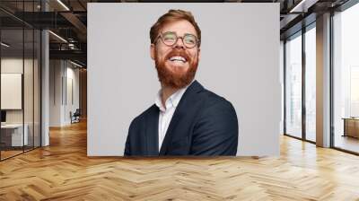 Cheerful red bearded businessman looking away Wall mural