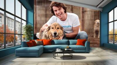 Cheerful volunteer with dog in shelter Wall mural