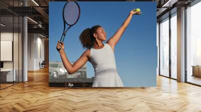 Confident black tennis player with racket and ball Wall mural