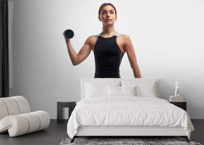 Confident lady exercising with dumbbells Wall mural