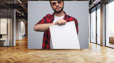 Cool guy showing blank paper Wall mural