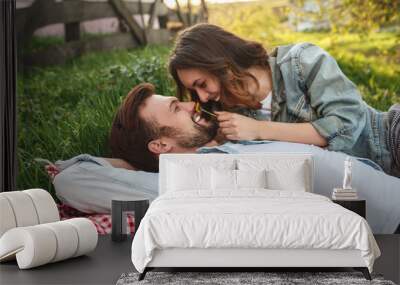 Couple having fun on grass Wall mural