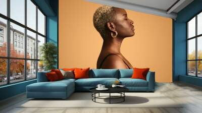 Dreamy black woman with closed eyes against beige background Wall mural