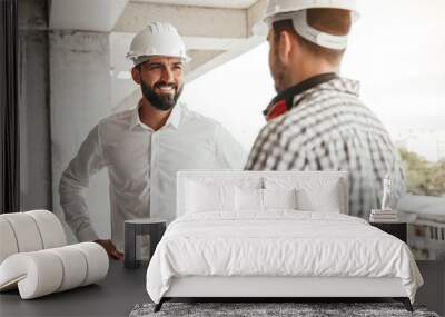 Entrepreneur speaking with worker on construction site Wall mural